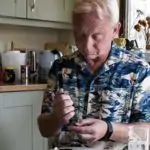 Man checking his blood sugar levels in a kitchen