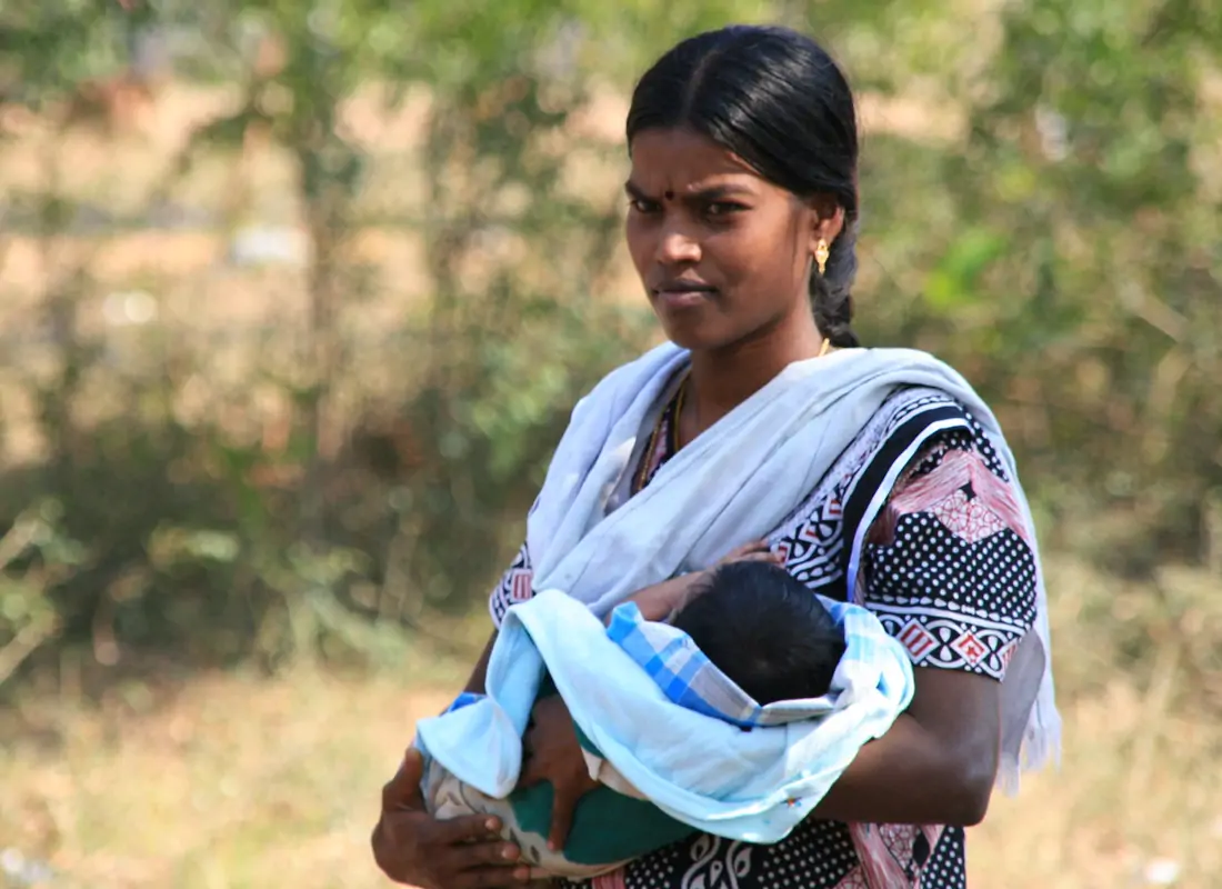 South Asian woman holding a baby