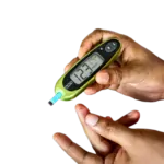 Person holding a finger stick glucose monitor