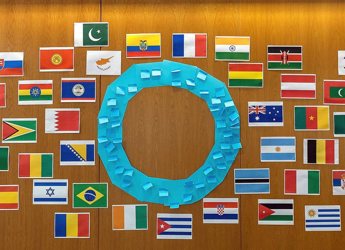 wall with blue circle surrounded by flags
