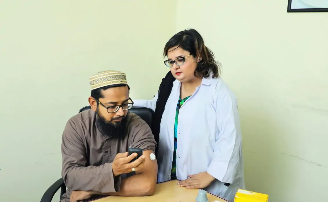 Man showing his CGM to a healthcare professional